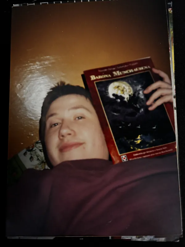 Karol at a Polish RPG convention in the 90s, holding an RPG book