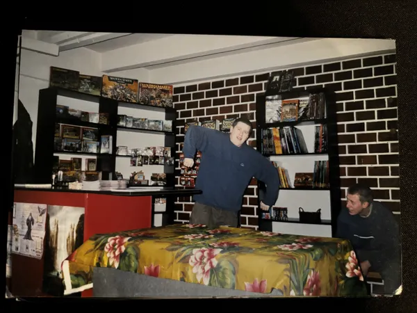 Karol at his RPG shop Hobbit around 2002, surrounded by RPG books and miniatures